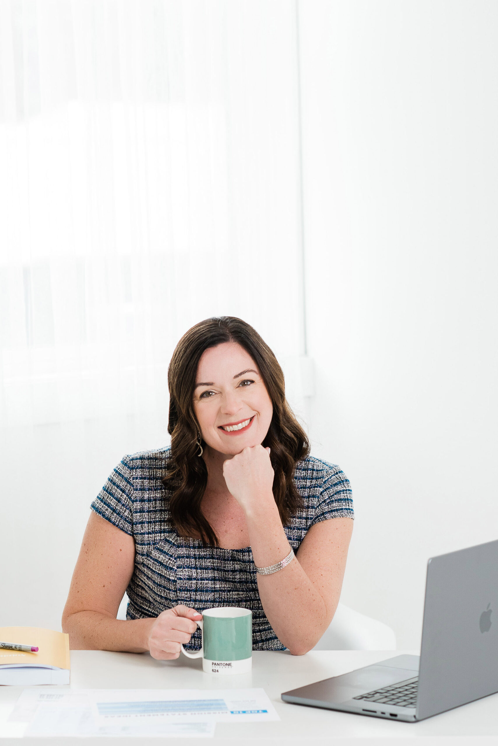 katie-interior-design-business-coach Interior Design Business Coach and podcast host Katie sitting at desk