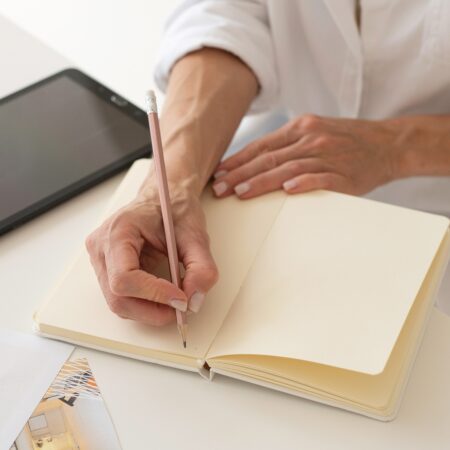 business owner writing Podcast SEO in notebook