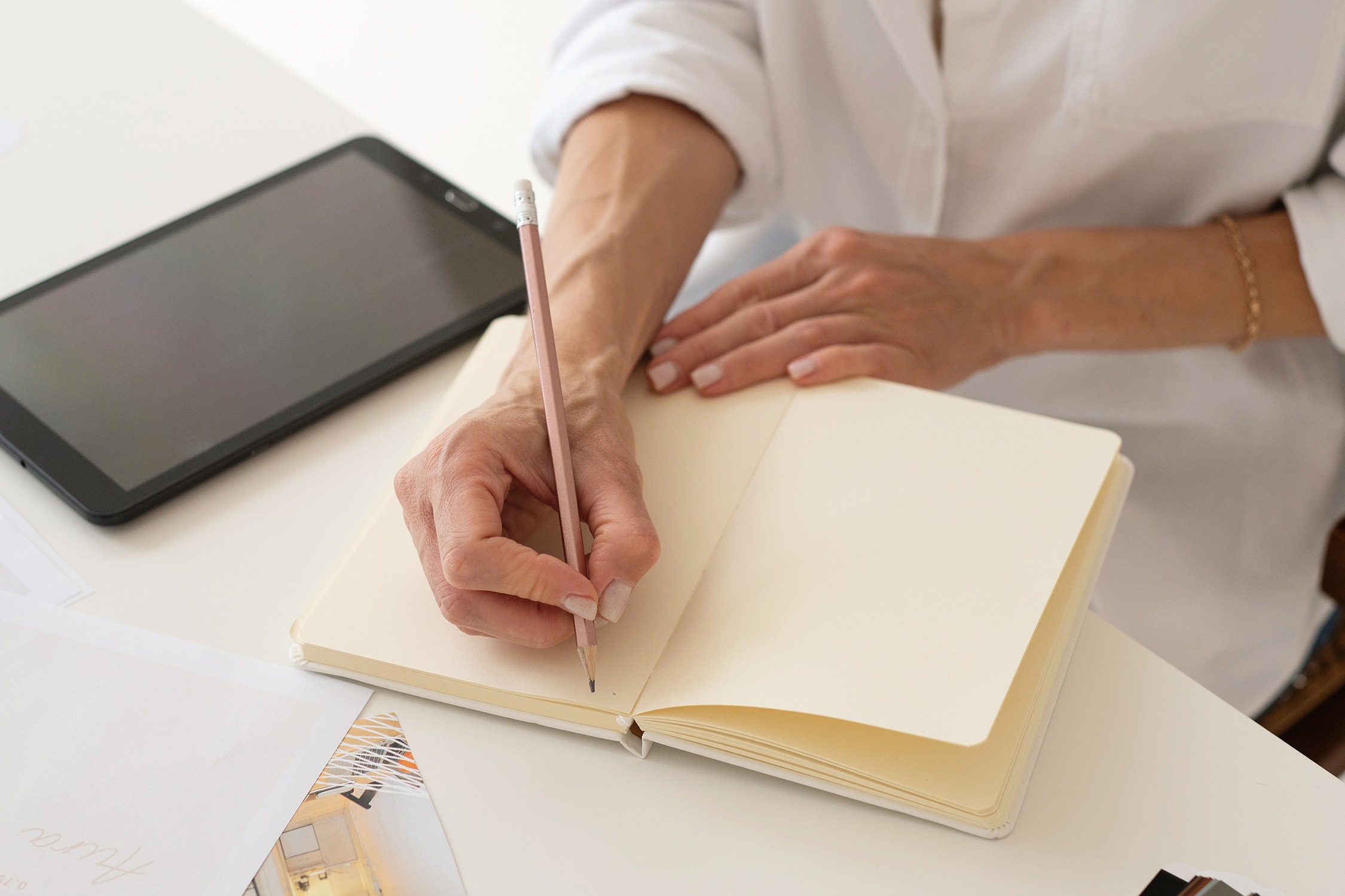 podcast-seo business owner writing Podcast SEO in notebook