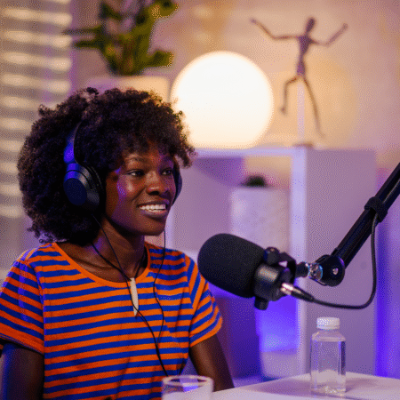 how-long-should-my-podcast-episodes-be Entrepreneur recording a podcast episode in a home studio with professional microphone and headphones, discussing podcast strategy and episode length tips.