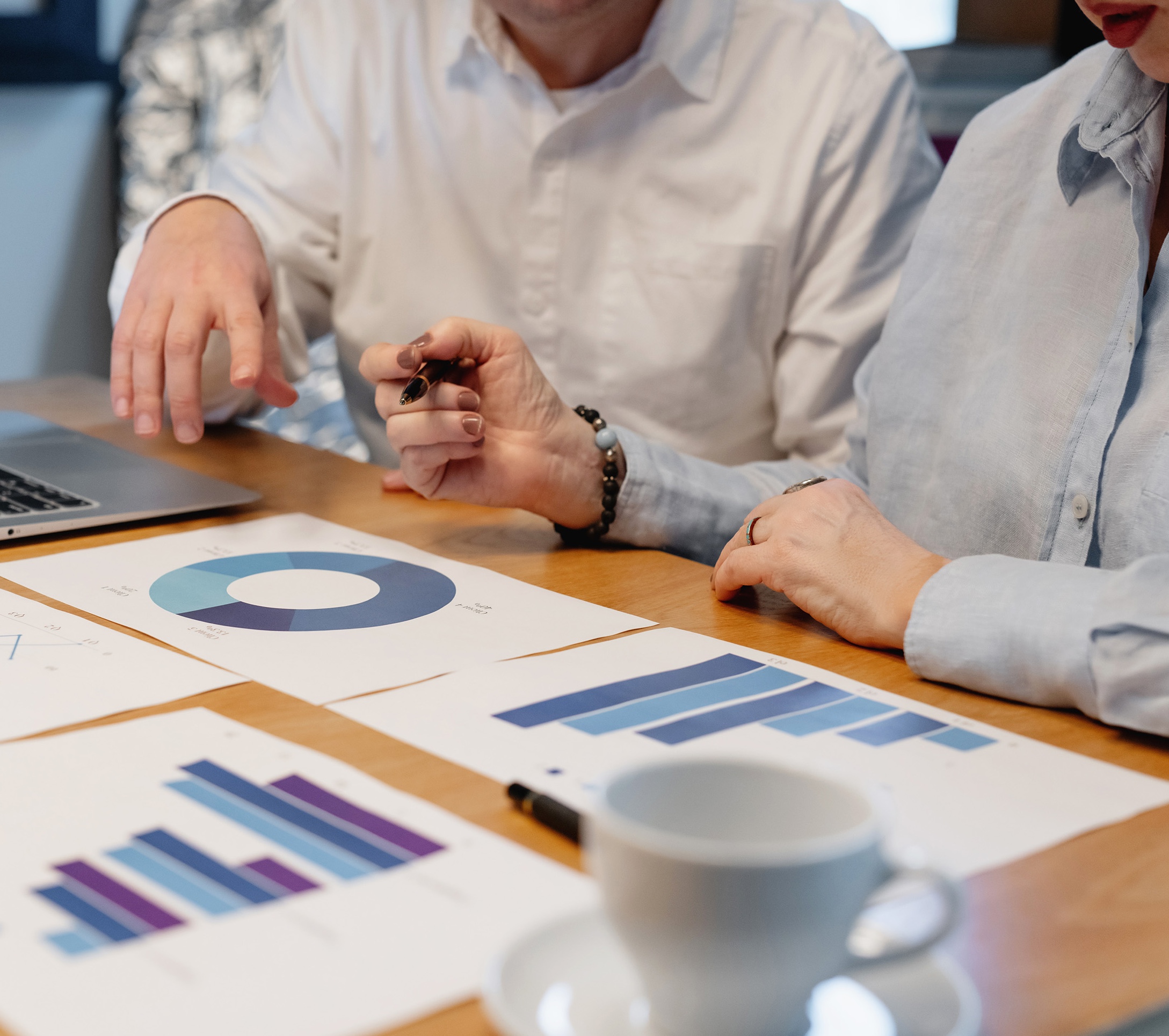 Podcasters reviewing growth analytics and planning sustainable podcast scaling strategy