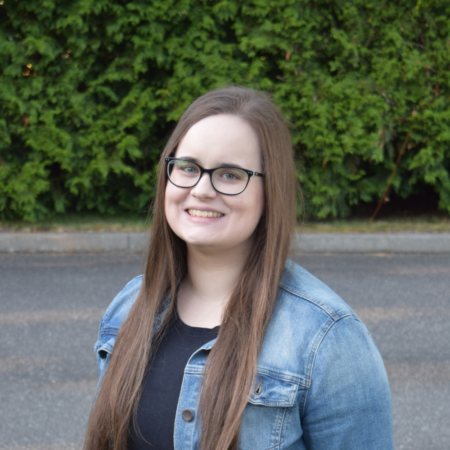 Hannah Davis, email marketing strategist, smiling headshot outdoors in a denim jacket